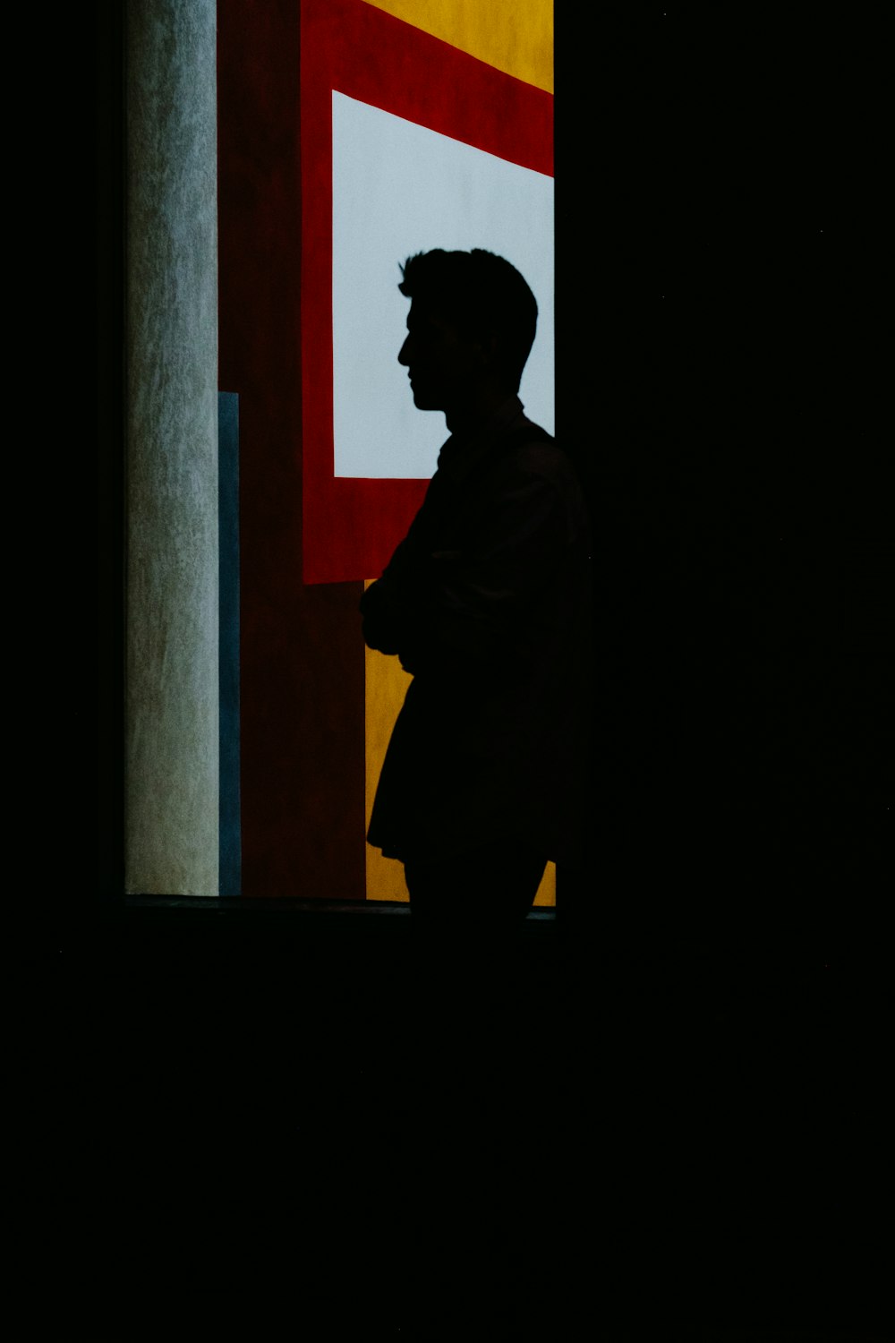 silhouette ofe man leaning on window