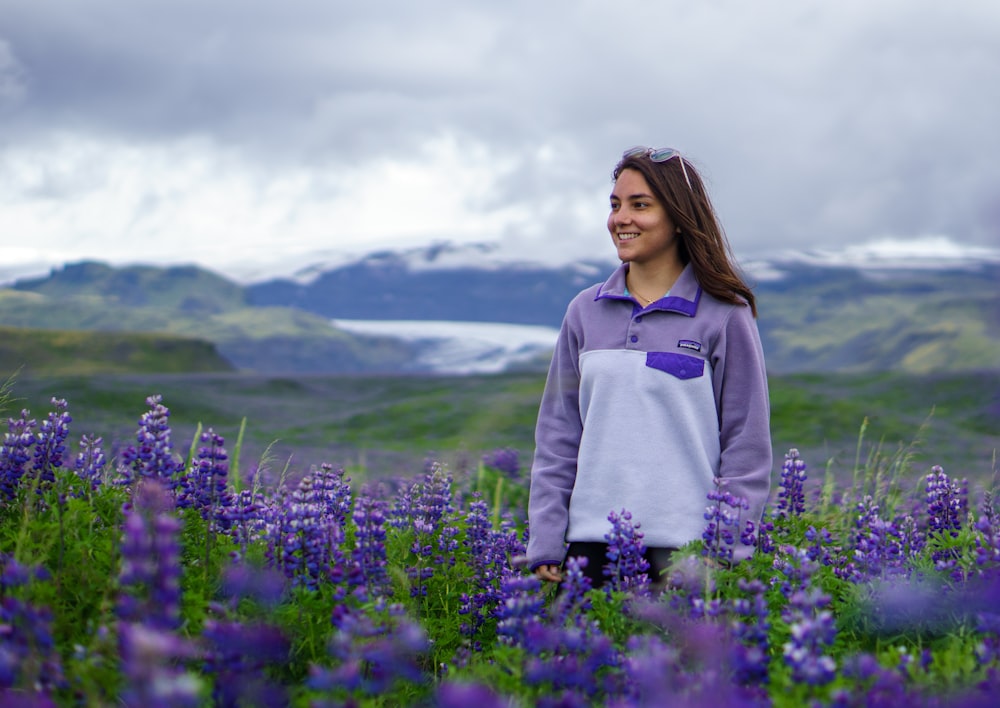 woman standing on lavender flower field during daytime