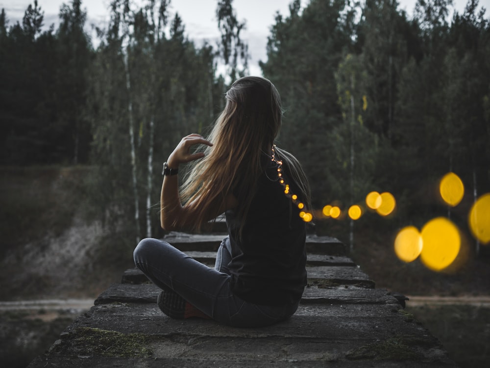 woman sitting on concrete edge