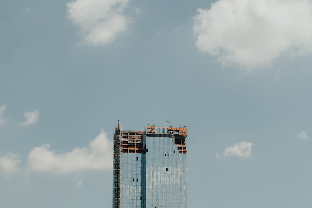 high rise building under cloudy sky