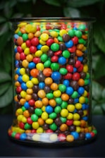 A colorful assortment of sweet candies in a decorative jar