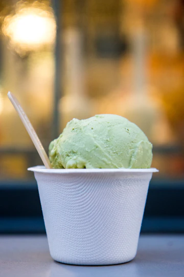 Pistachio gelato scooped into a cup