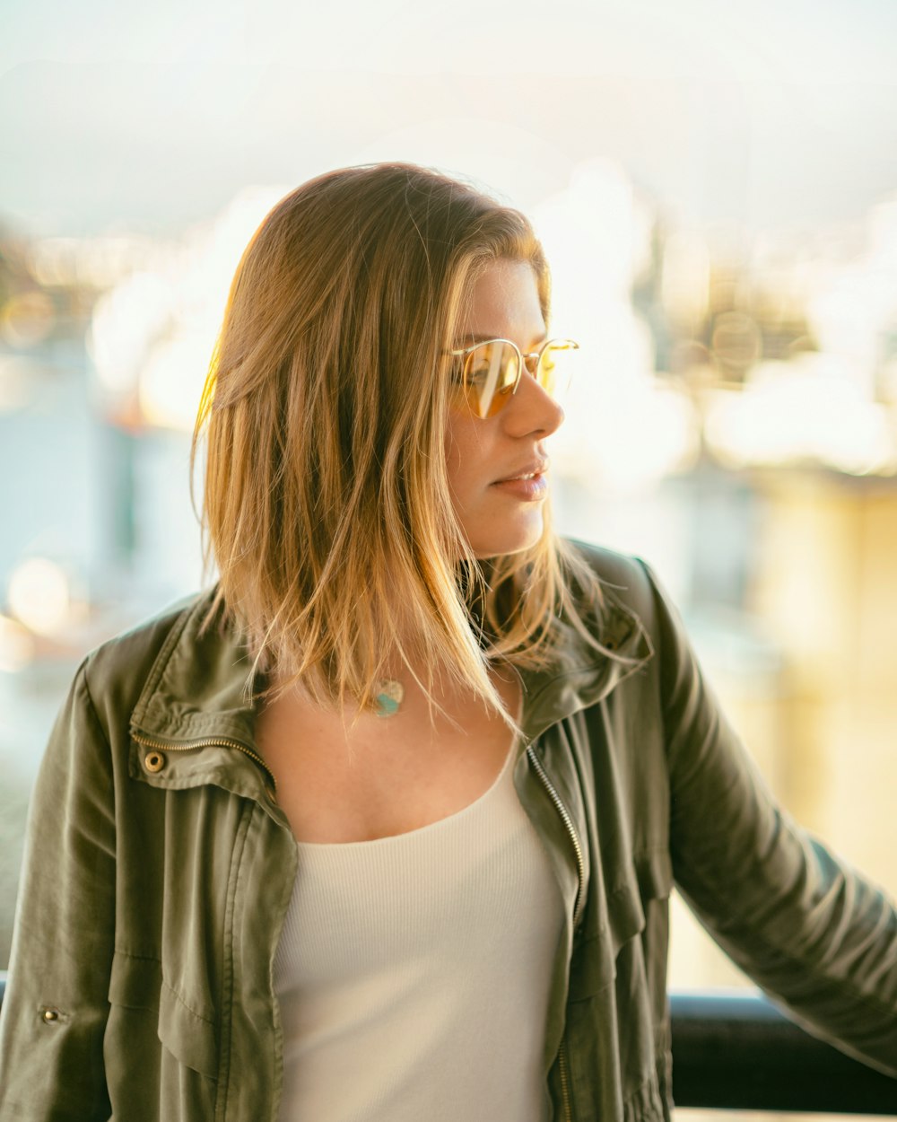 selective focus photography of woman wearing long-sleeved shirt and sunglasses