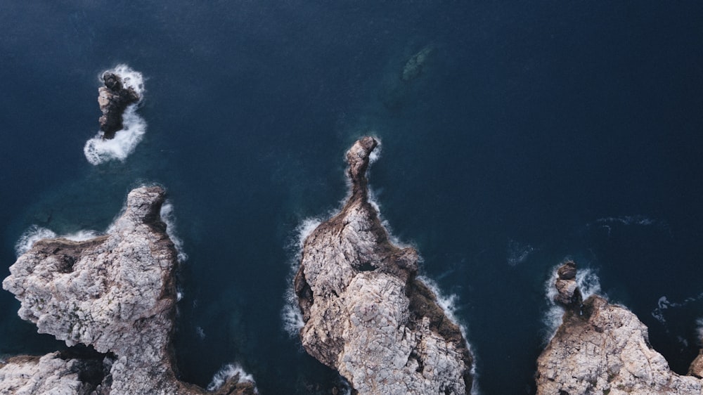 aerial photography of rock formations in ocean
