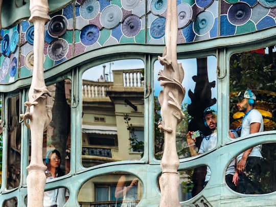 people reflected on glass windows in Casa Batlló Spain