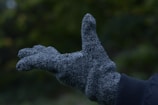 Close-up of a pair of charcoal grey wool blend gloves with fleece lining.