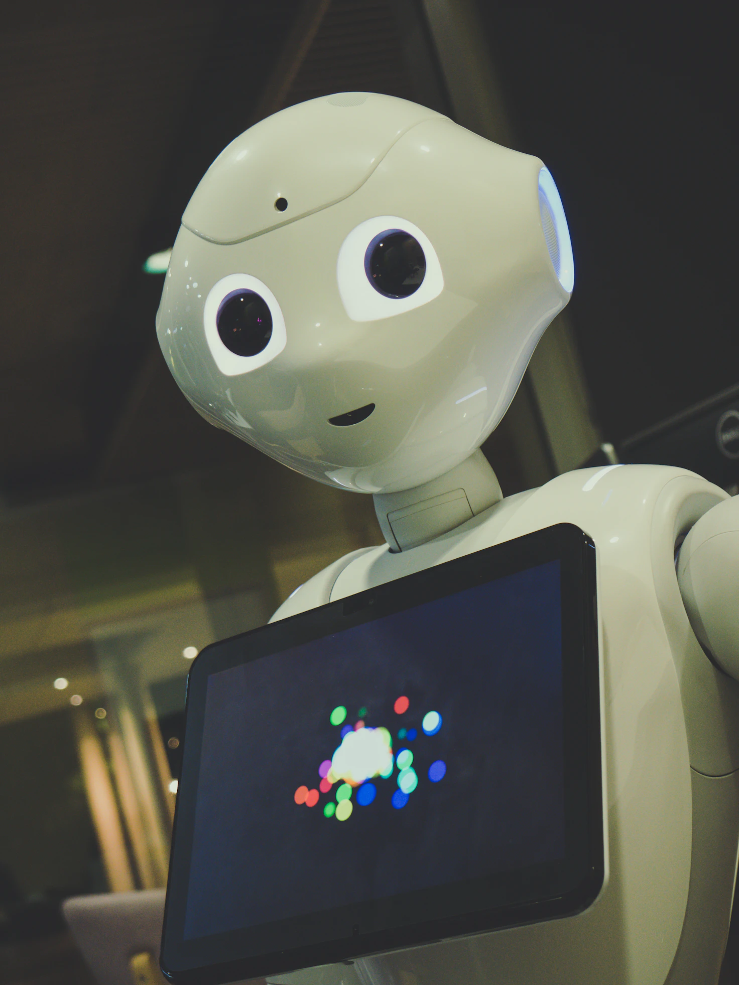 a robot is holding a tablet with a picture on it