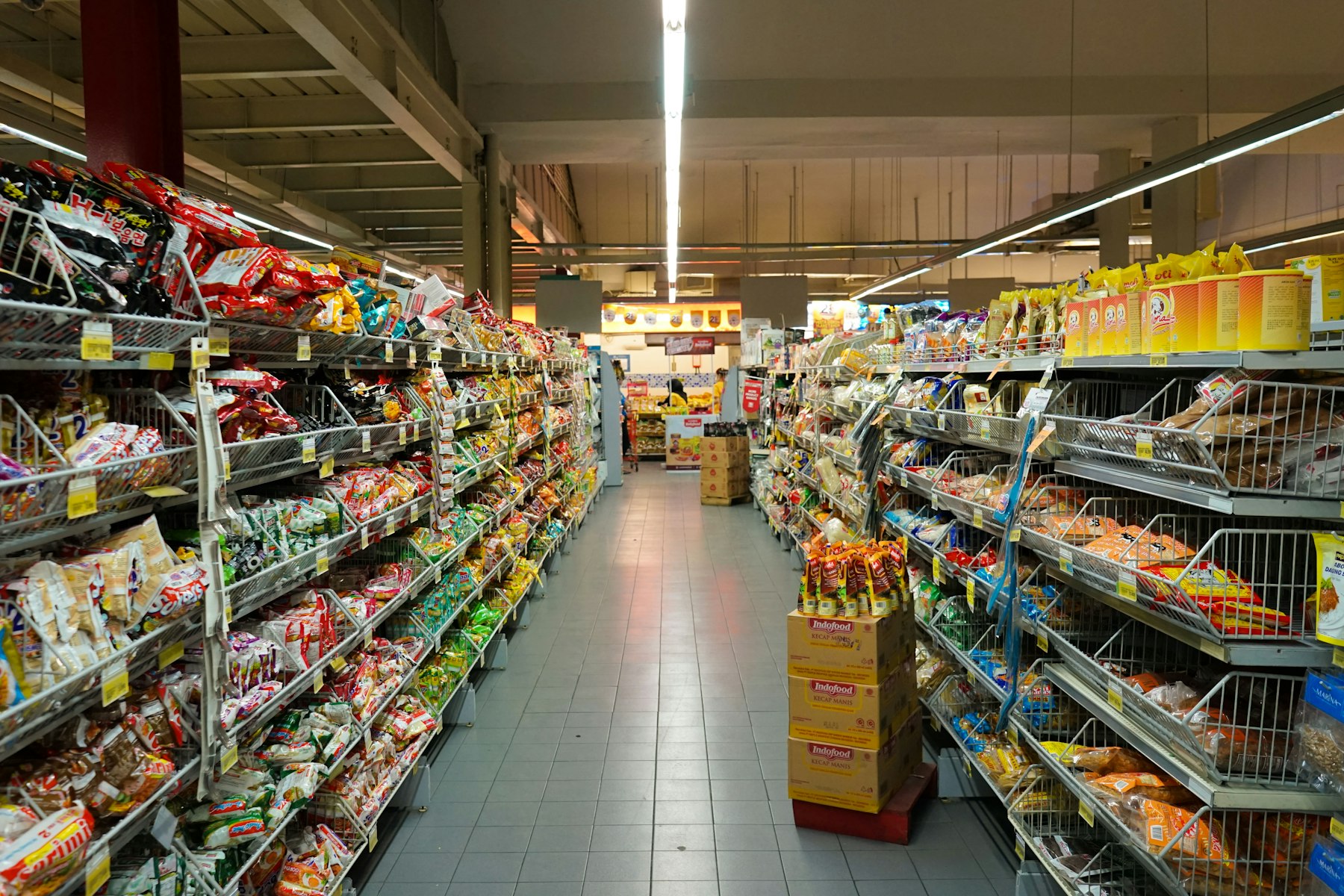 Busy supermarket aisle with product shelves