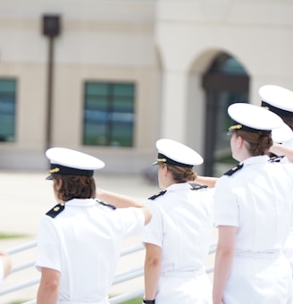 five person wearing white suits