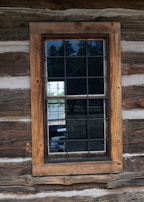 A sturdy glass window installed in a cozy lakeside cabin, showcasing clear views outside.