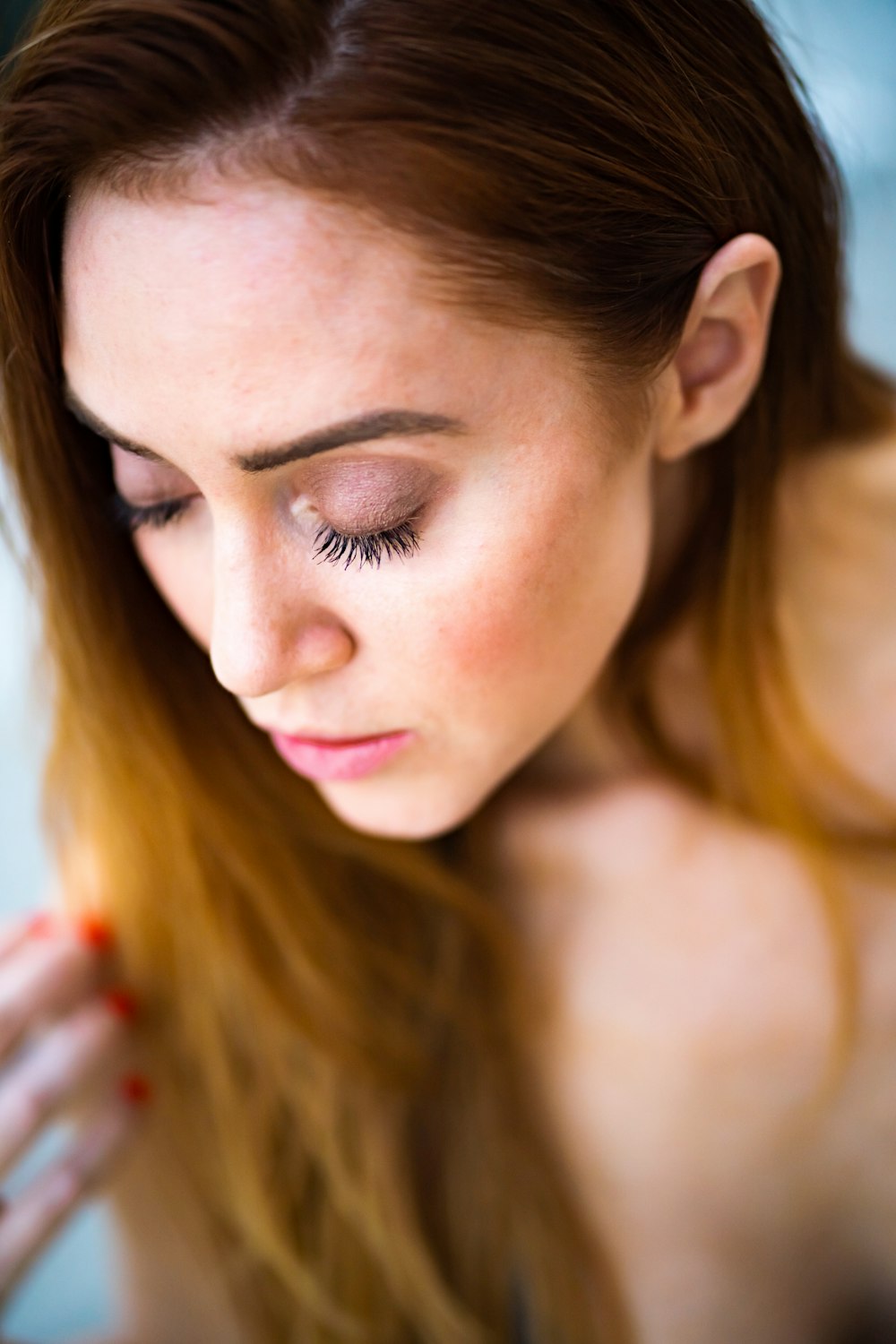 selective focus photography of woman closing her eyes with brown eyeshadow
