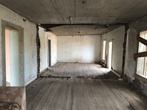 A cluttered Arlington home interior contrasted with its bright, empty space after selling as-is.