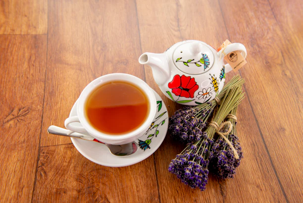 A cozy kitchen scene with a steaming cup of tea beside a lavender sachet and a jar of hand salve from the farm.