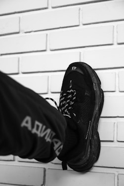 person wearing black Nike Vapor Max shoe