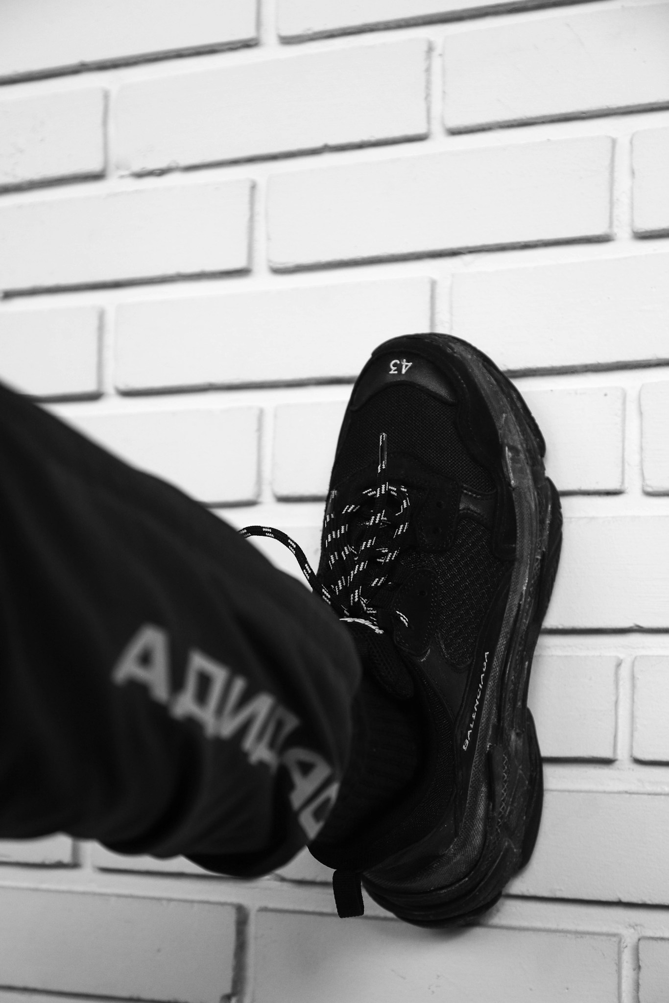 person wearing black Nike Vapor Max shoe