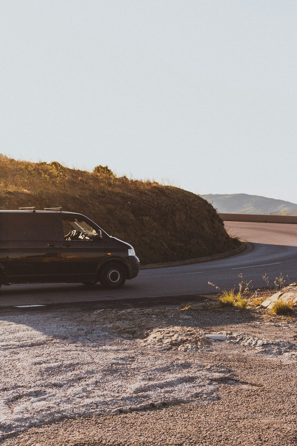 black van beside brown grass field