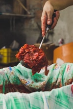 person making a chili sauce