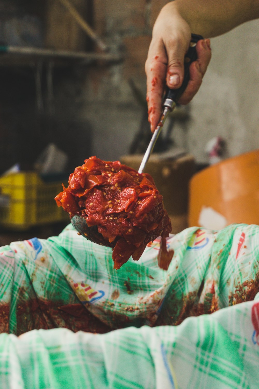 person making a chili sauce