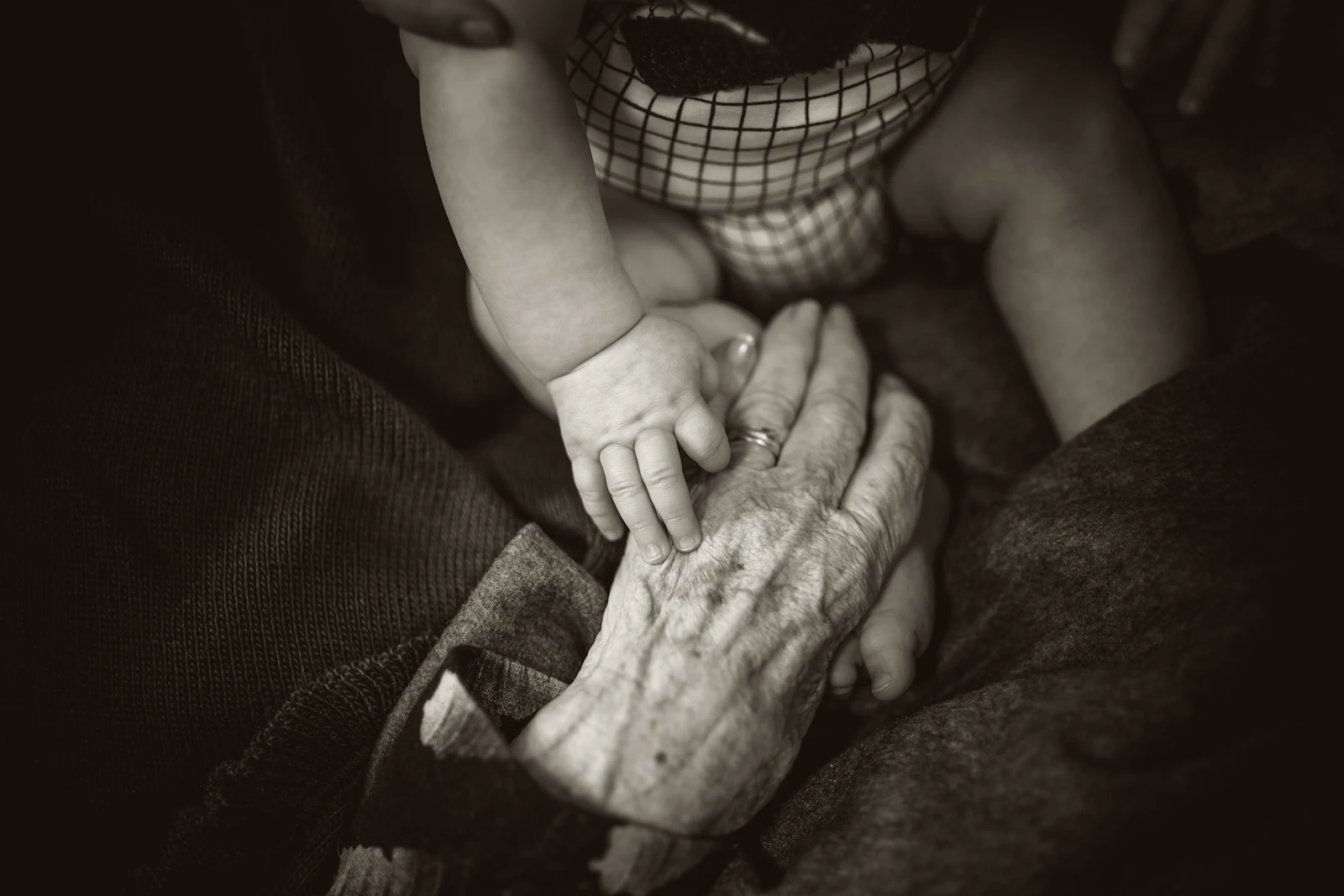 An older woman holding a small child's hand