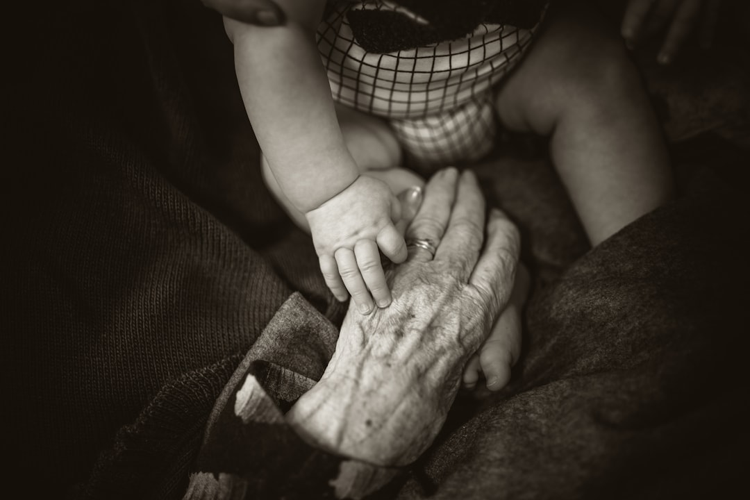 an older woman holding a baby