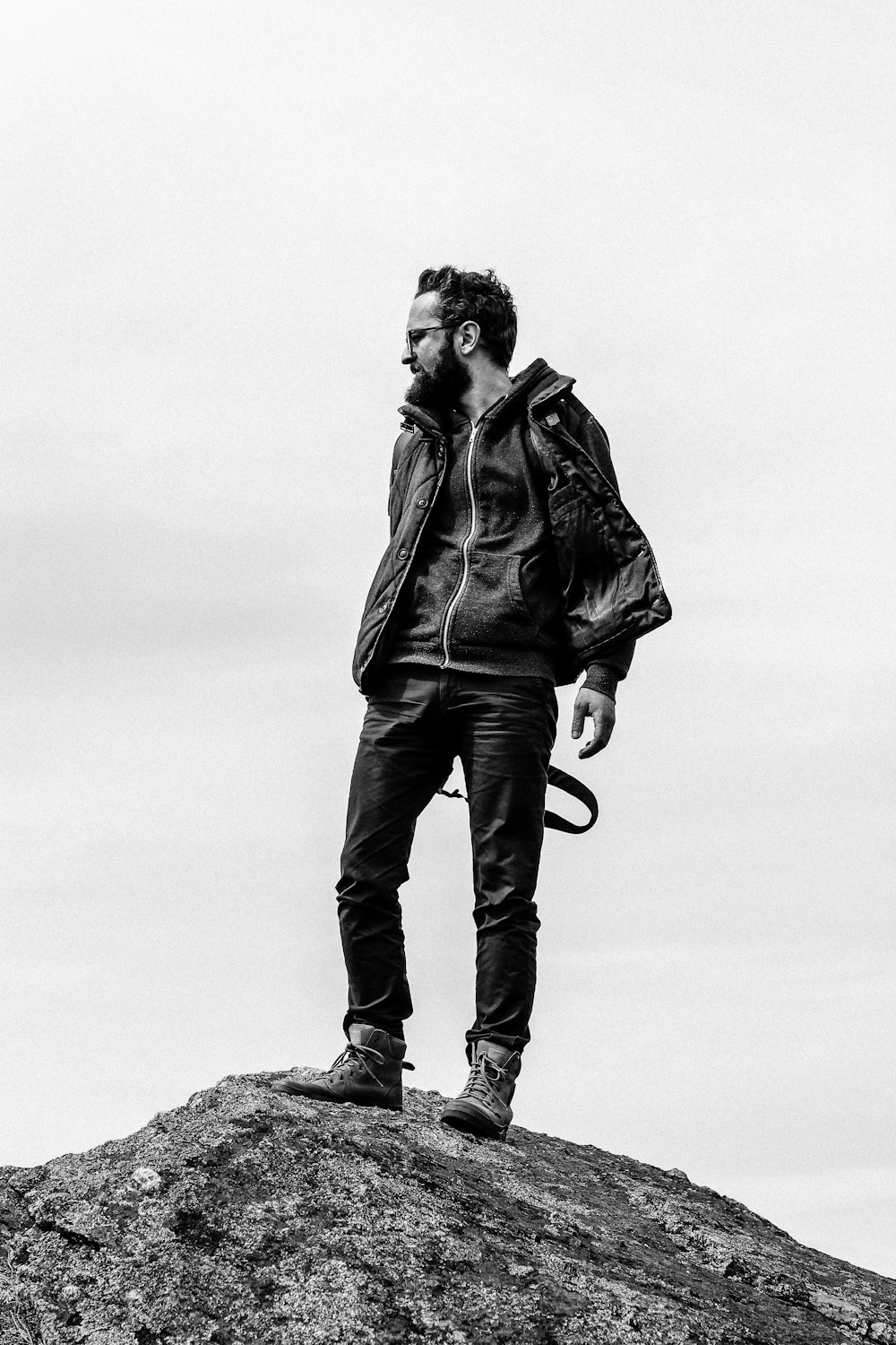 man stepping on black rock formation