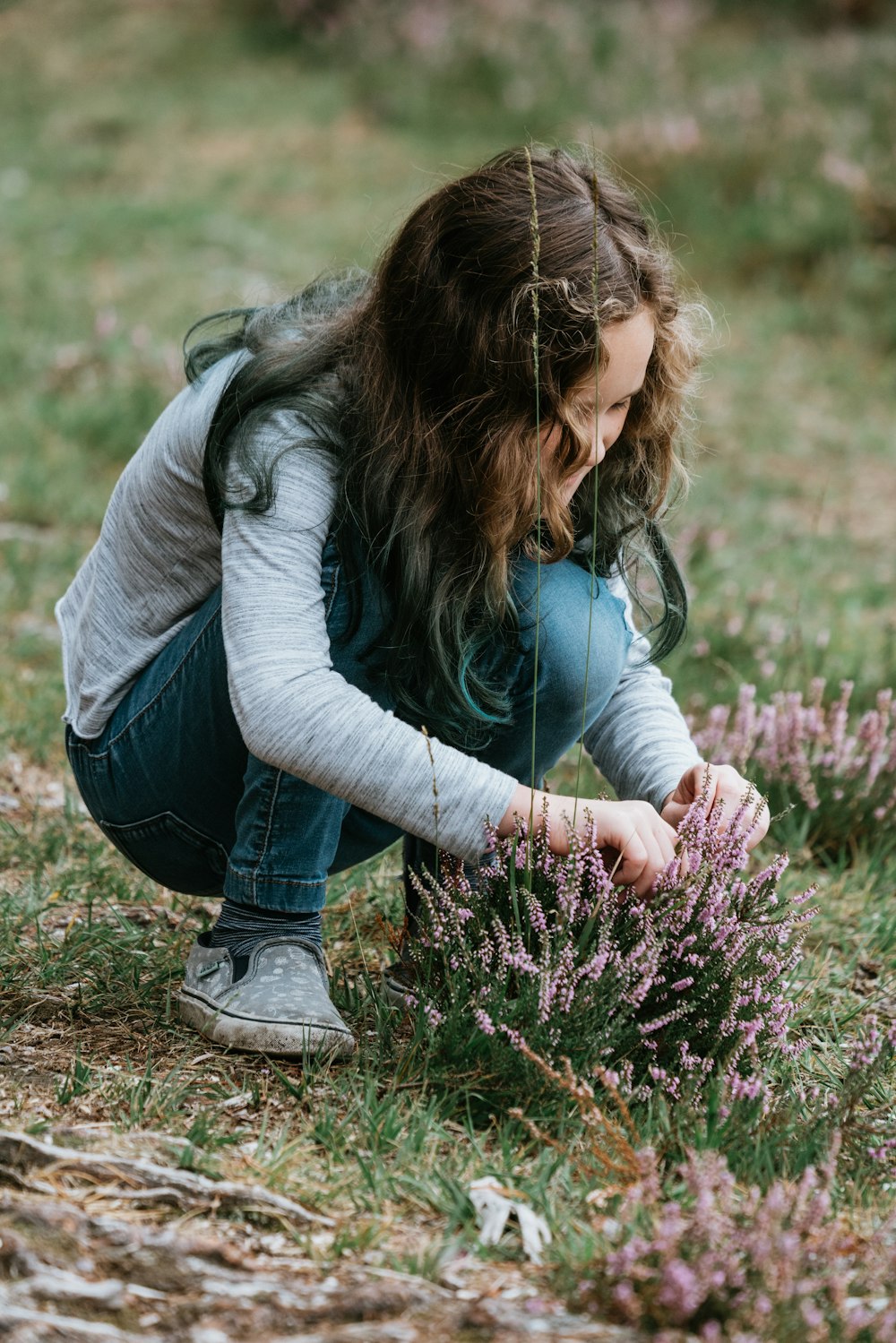 woman holding purple flower