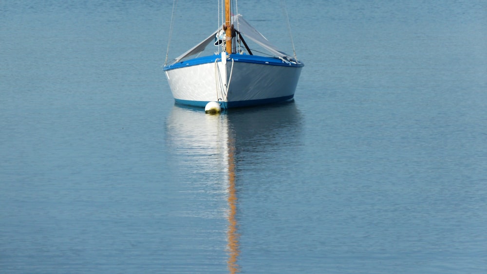 grey and blue boat passing on water