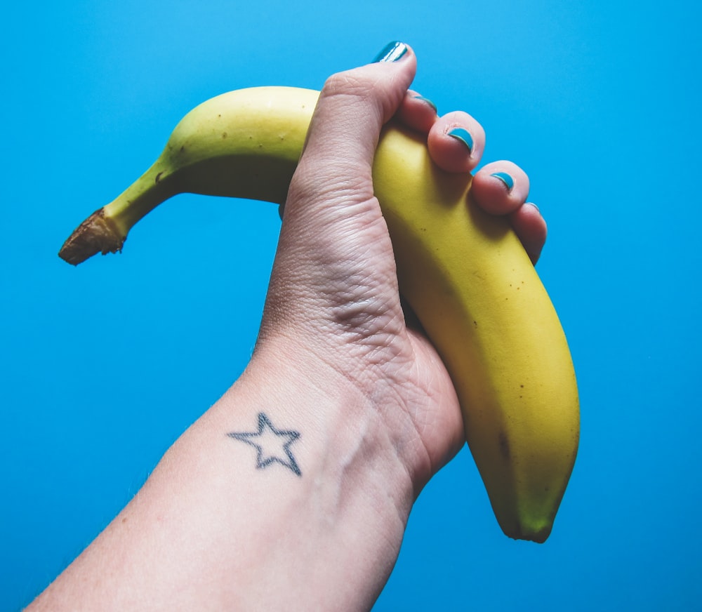person holding ripe banana