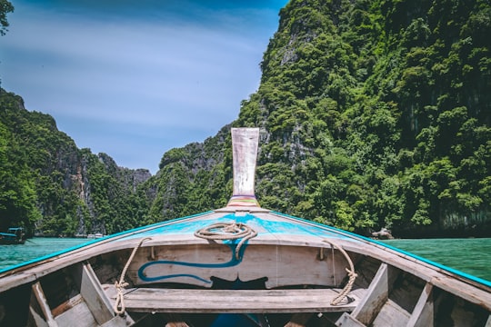 brown and brown wooden canoe boat in Pileh Lagoon Thailand