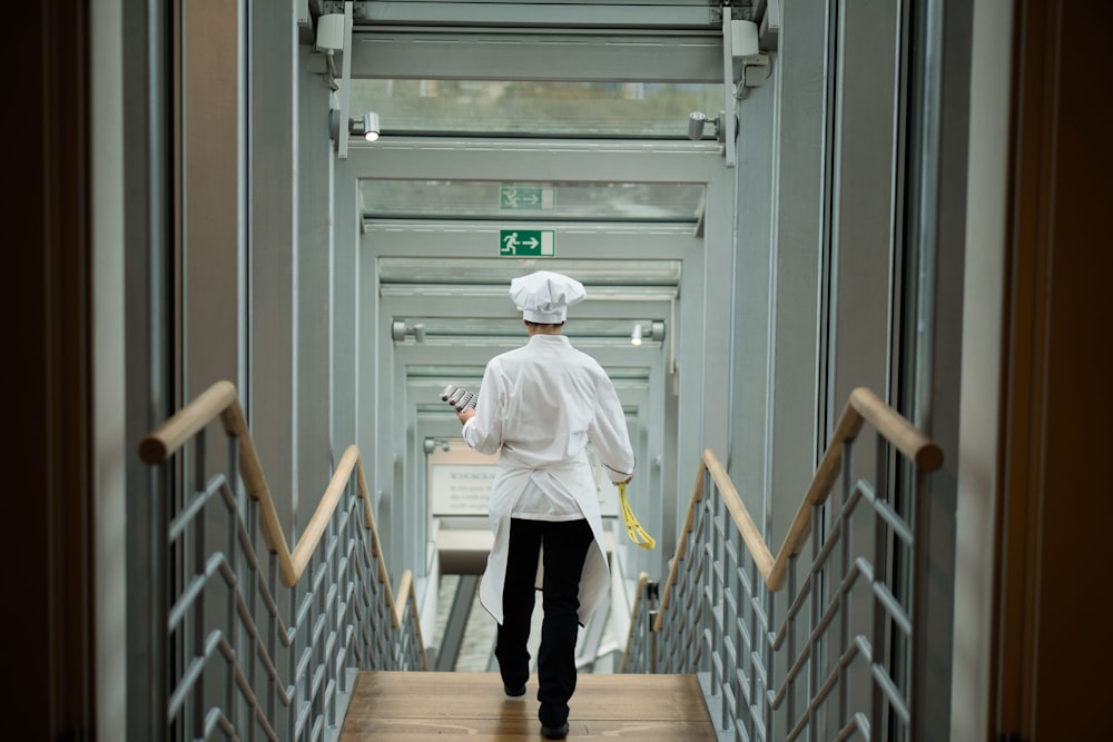 person wearing white apron walkin on stairs