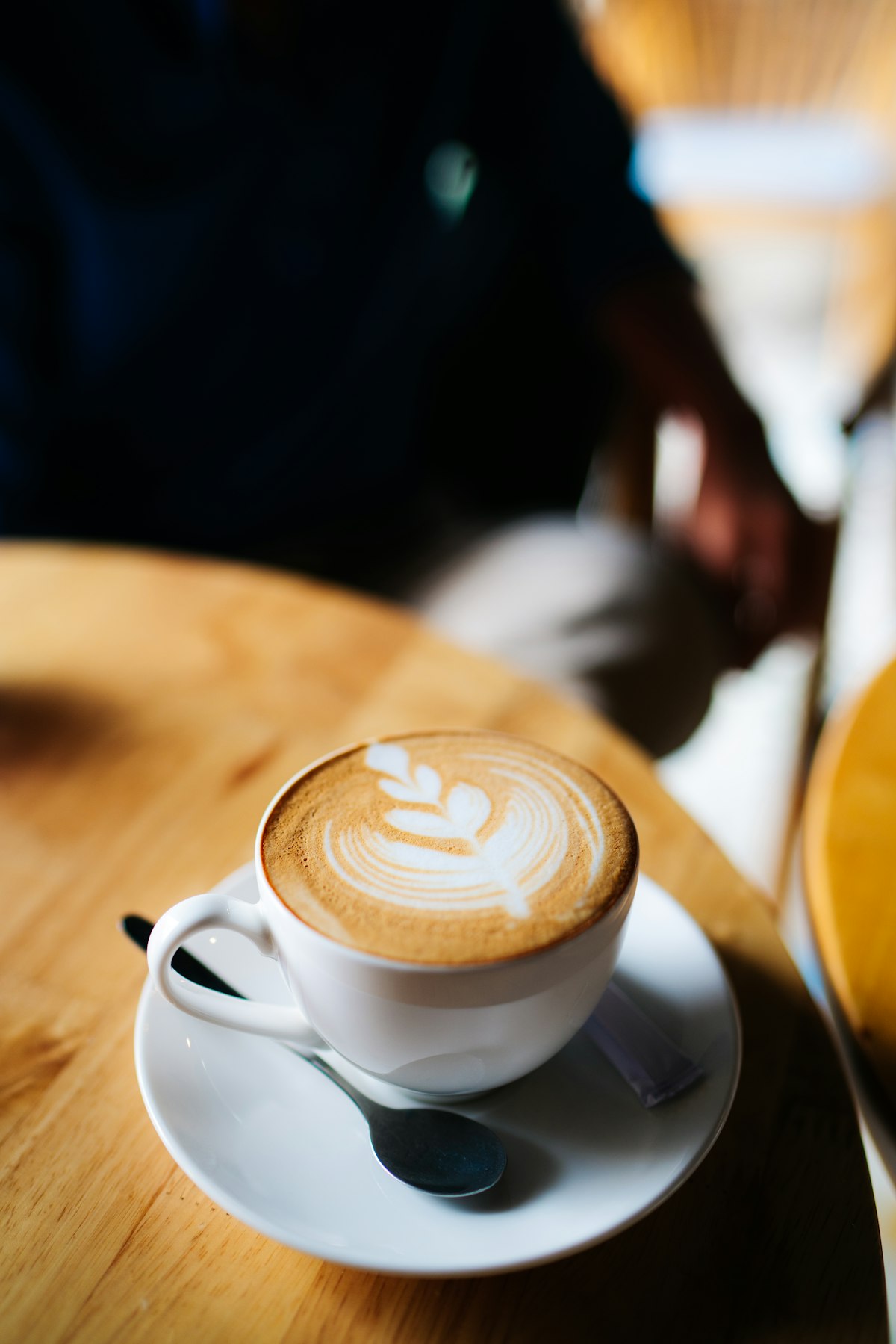 Top-down view of a latte with foam art on a wooden surface