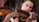 Close-up of a violinist's hands skillfully playing a violin on stage.