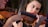 Close-up of a violinist's hands skillfully playing a violin on stage.