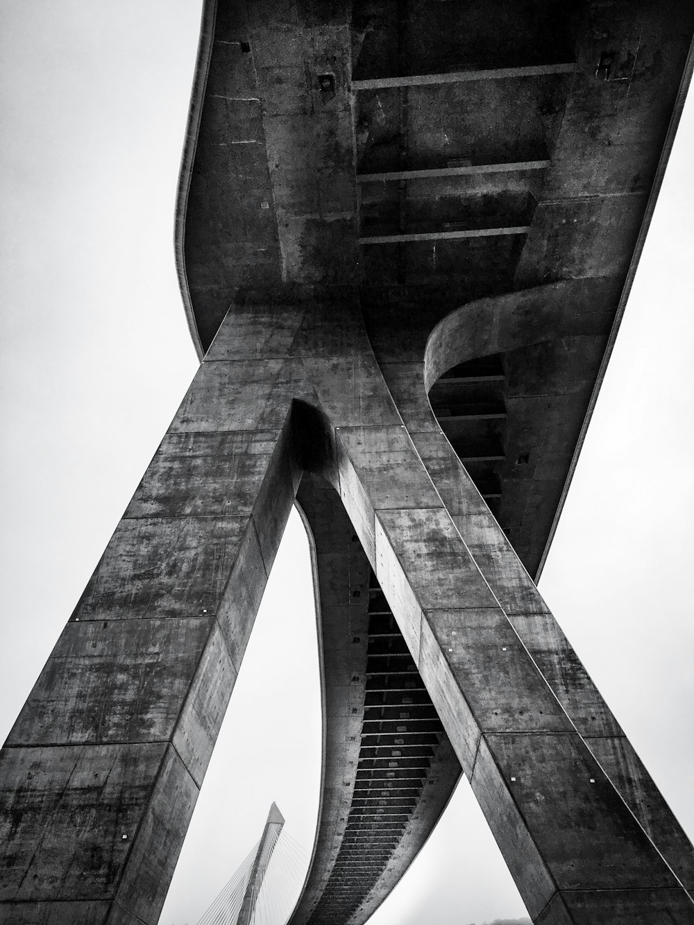 grayscale photo of concrete bridge