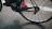 Close-up of a road bike wheel spinning fast on a smooth asphalt road.