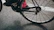 Close-up of a road bike wheel spinning fast on a smooth asphalt road.