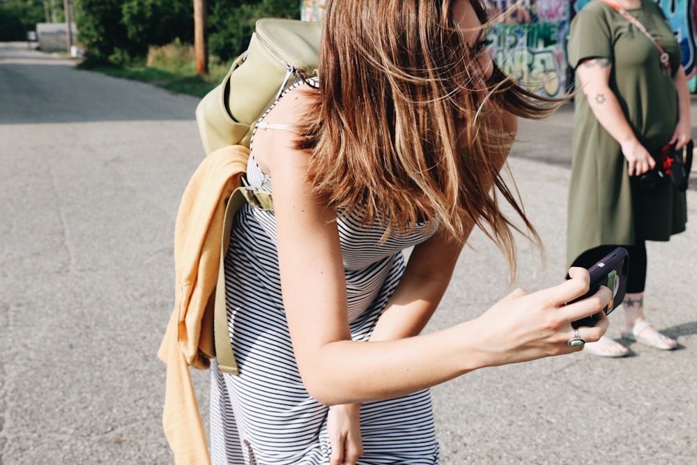 woman taking pictures outdoors