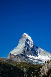 A crisp, wide-angle shot of Mount Temple’s snow-capped peak under a clear blue sky.