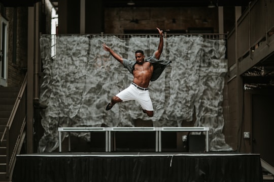 man raising his both hands while on air in front of stage in Austin United States