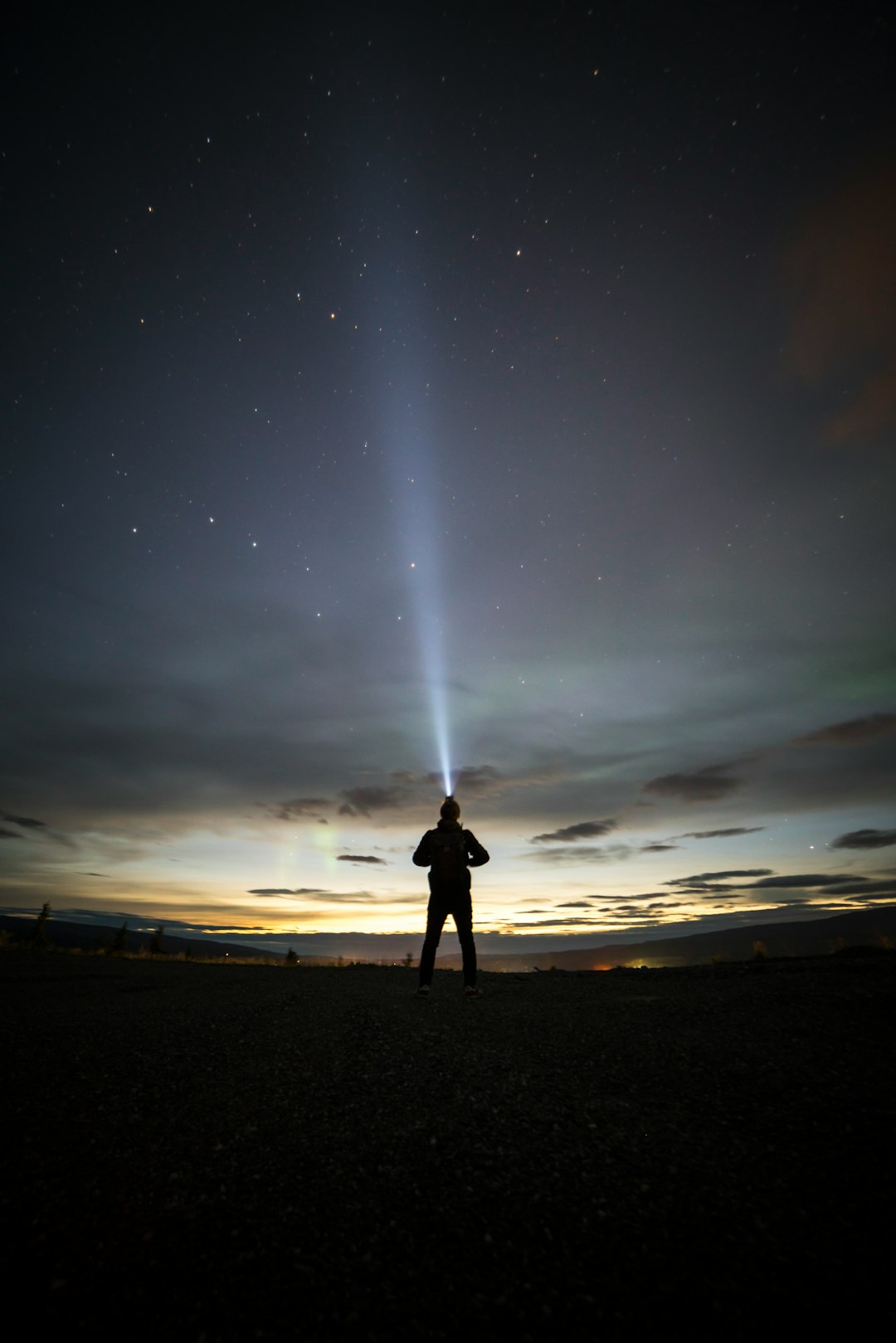 silhouette of person under starry sky during sunset