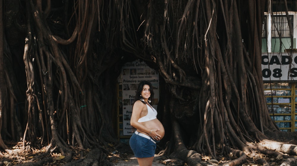 woman pregnant while holding belly