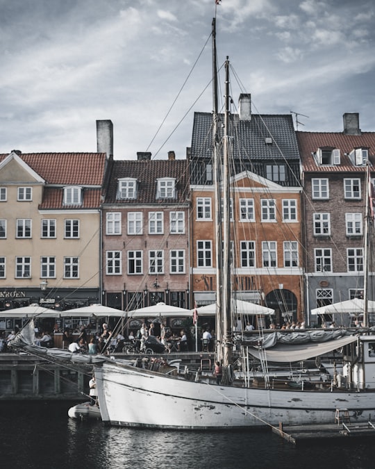 gray boat docked near houses in Nyhavn Denmark