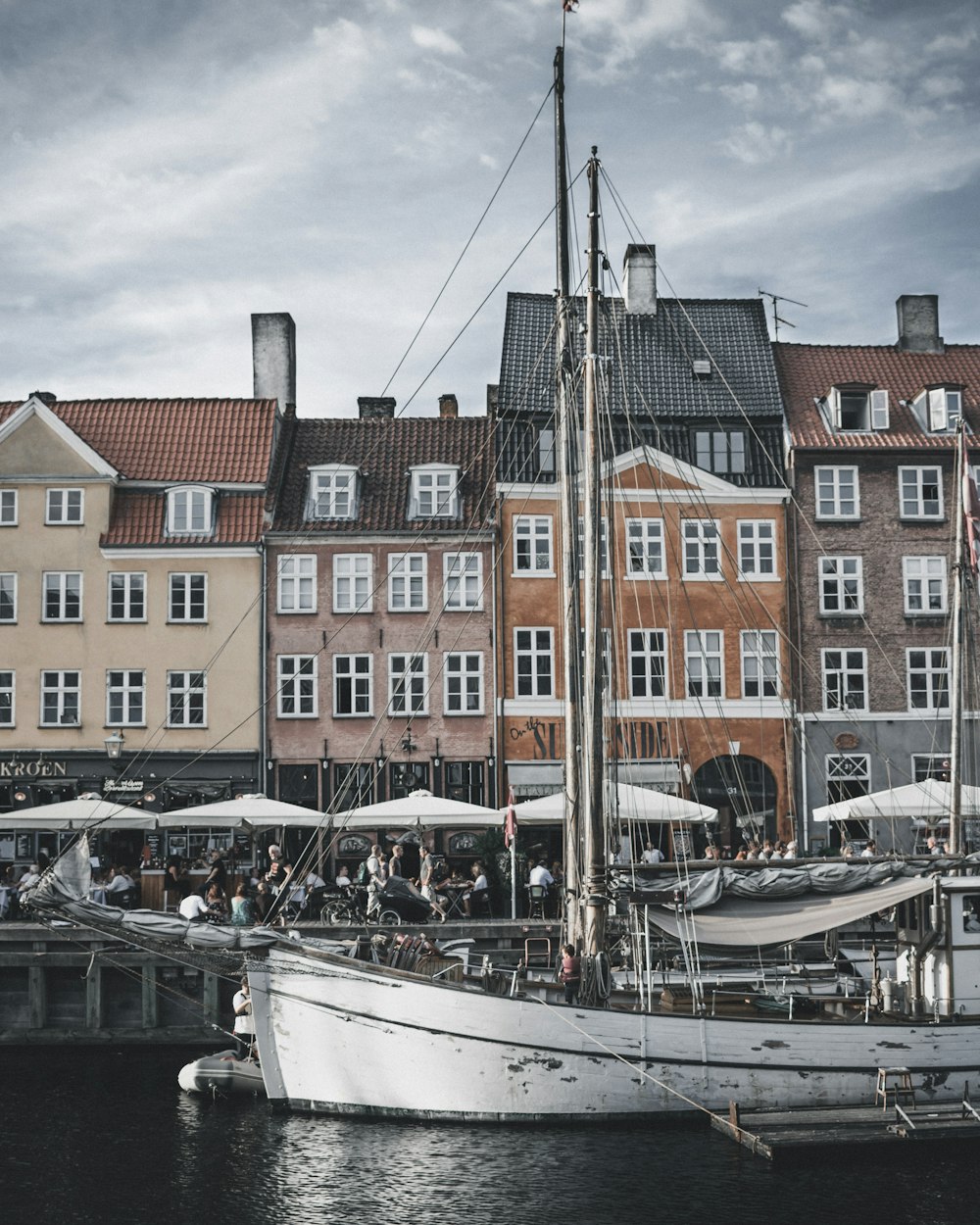 gray boat docked near houses