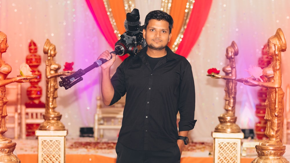 smiling standing man carrying camera