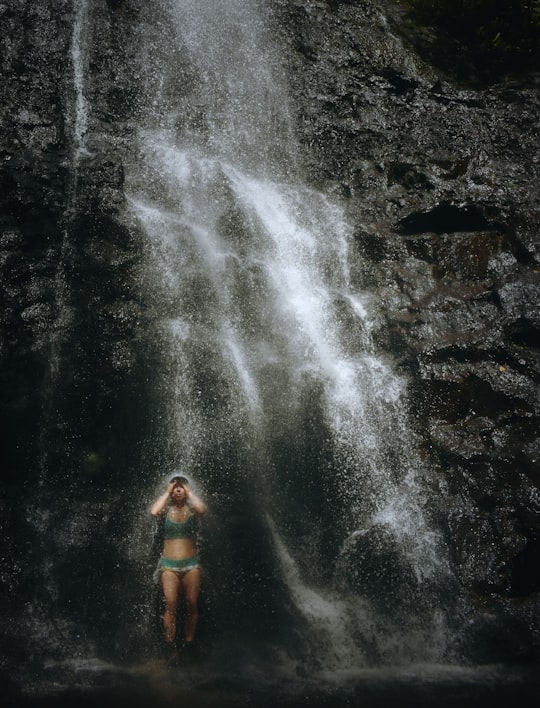 woman taking a bath in waterfalls in Ka‘au Crater United States