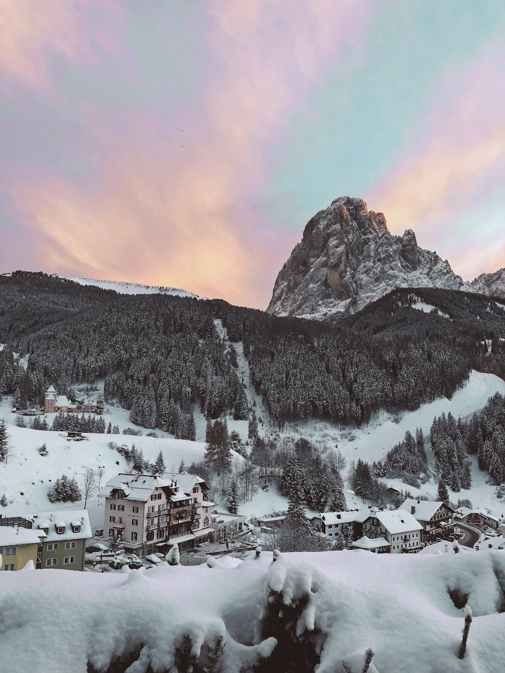 houses beside mountain cover by snow