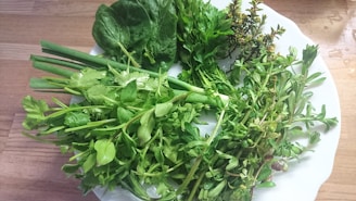 A variety of fresh herbs on a wooden table.
