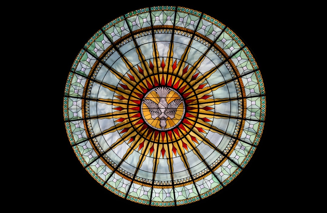  round white, beige, and red stained glass roofing dove