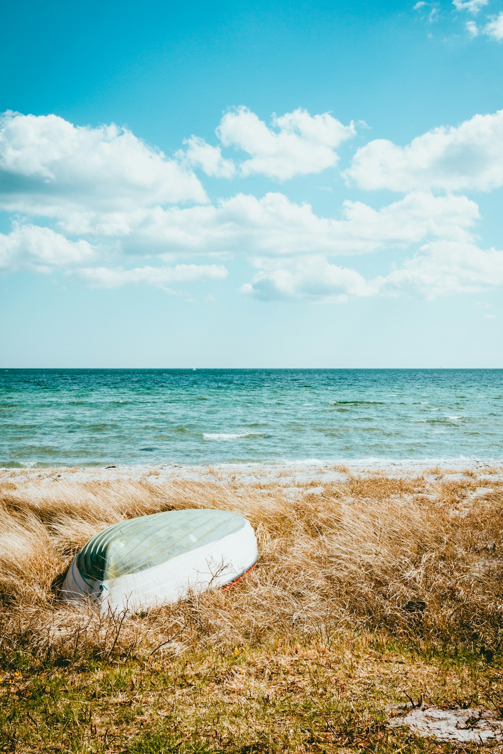 boat on beach under blue sky