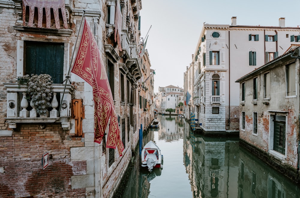 white boat beside concrete building